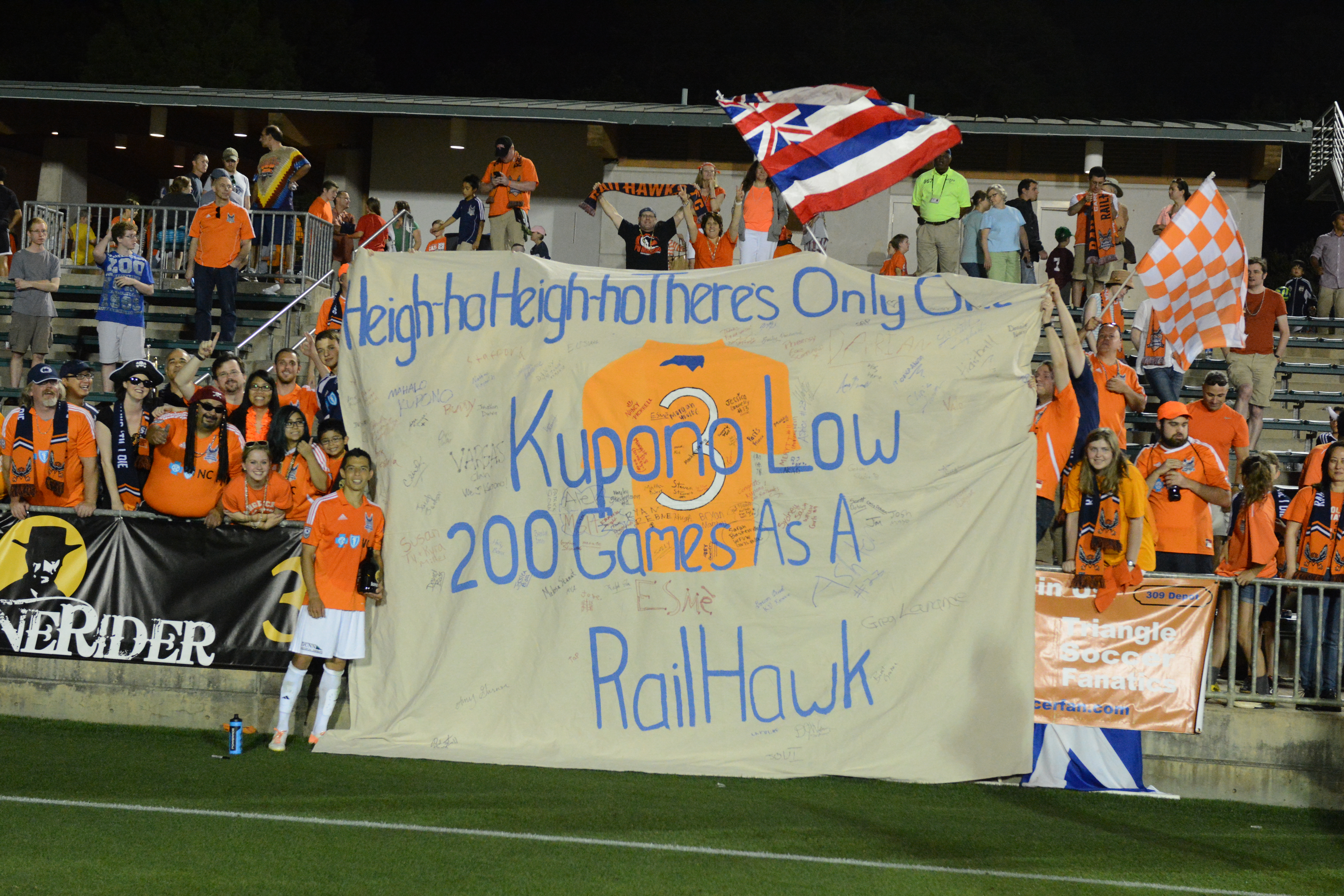 Carolina fans present Kupono Low with a banner celebrating his 200th game for the team (Photo: Carolina Railhawks)