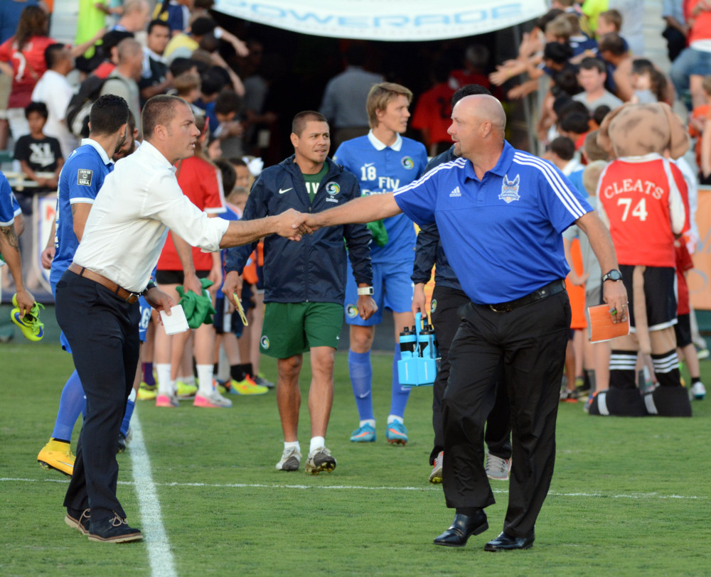 The Cosmos' Gio Savarese and the Railhawk's Colin Clarke shake hands earlier in 2015. (Photo: Rob Kinnan-Carolina RailHawks)