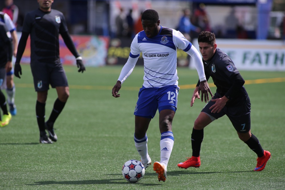 Kareem Moses is trailed by Kevin Venegas (Photo: FC Edmonton)