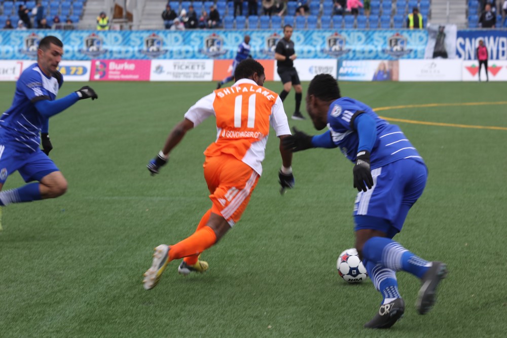 Tiyi Shipalane runs past an FC Edmonton defender during the two teams' spring matchup. (Photo: FC Edmonton)